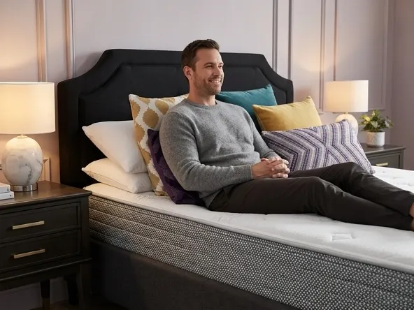 Win a Sleep Country Bedroom Makeover, man relaxing against pillows on quality mattress