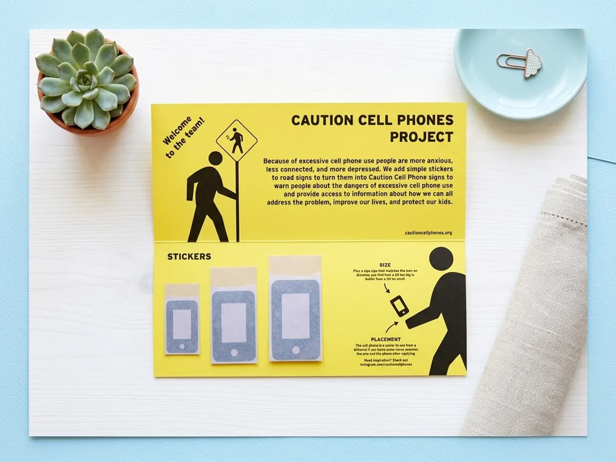 Spread Awareness with a FREE Caution Cell Phones Sticker Kit, stickers arranged on styled white table