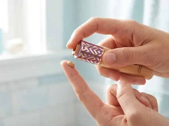 Enter to Win a FREE Tarte 2026 Holiday Collection Set, dispensing liquid foundation onto fingertip