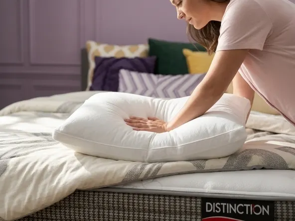 Enter to WIN a FREE $9,999.99 Sleep Country Bedroom Makeover, hand testing pillow softness and support